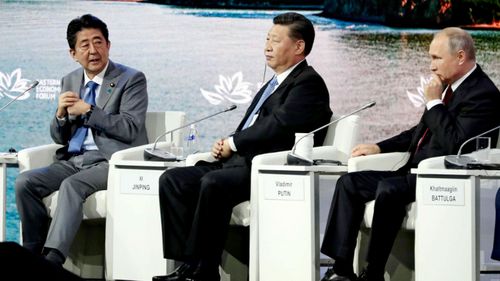 From left:  Japan's Prime Minister Shinzo Abe, China's President Xi Jinping and Russia's President Vladimir Putin at the economic conference.