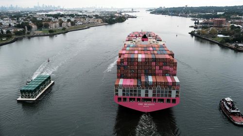 A cargo ship moves under the Bayonne Bridge as it heads out to the ocean in Bayonne, New Jersey. 