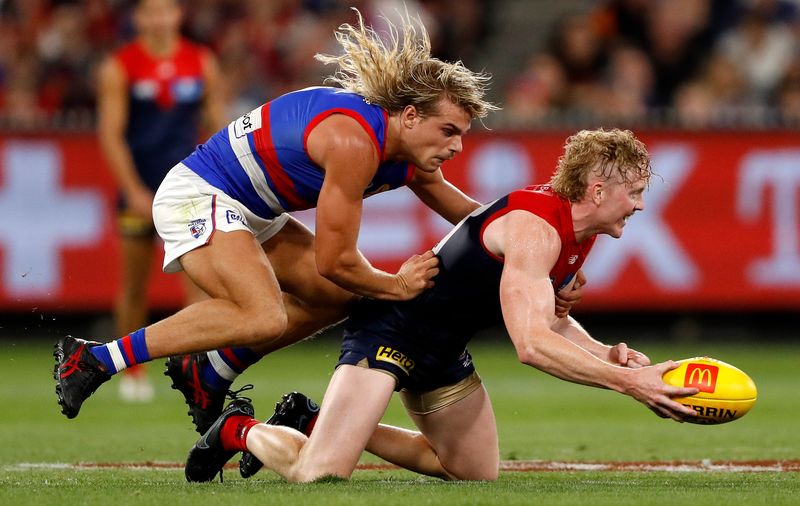 Melbourne&#x27;s Clayton Oliver is tackled by Bailey Smith of the Western Bulldogs.