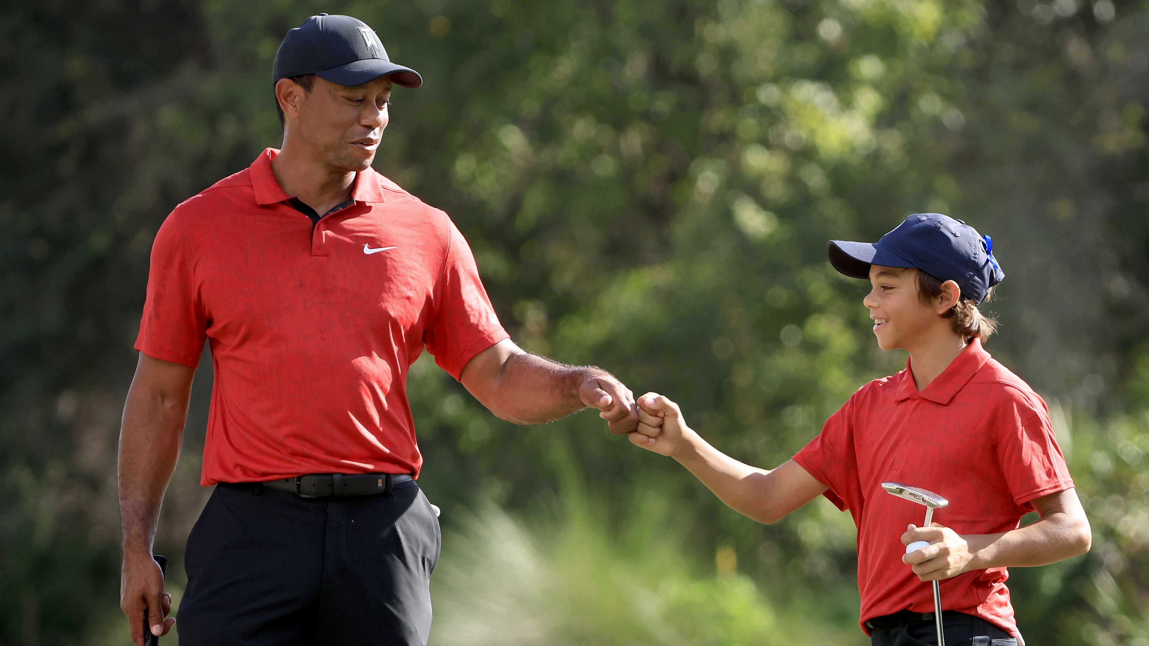 Tiger Woods and Charlie Woods celebrate a birdie on the 12th hole during the final round of the PNC Championship.