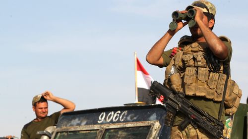 Iraqi forces hold a position about 30km from the ISIS stronghold of Mosul. (AFP)