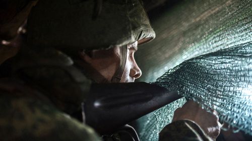 A pro-Russian serviceman sits in the advanced trenches of the people's militia of the Donetsk People's Republic in the Yasne village area, Donbas