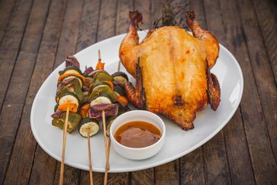 Whole smoked chicken with Mediterranean vegetable skewers