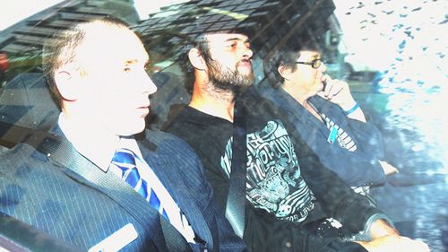 Marcus Stanford (centre) arrives at the Sydney Police Centre after being extradited from South Australia by NSW Police, Sydney, Thursday, June 11, 2015