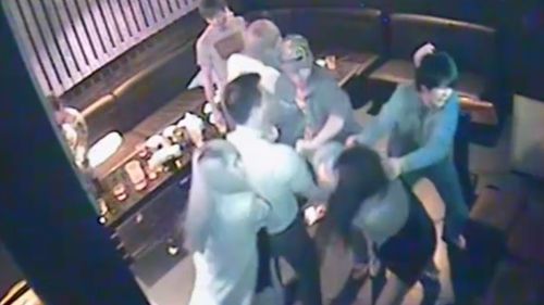 One of the male attackers at the Melbourne karaoke bar can be seen grabbing the female victim by the hair before throwing her to the ground. (Victoria Police)