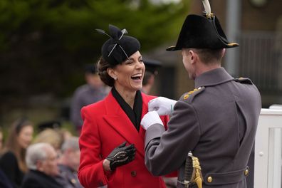 Kate, Princess of Wales gets a leek on her coat at a St David's Day parade with members of the 1st Battalion, The Welsh Guards in Windsor England, Wednesday, March 1, 2023