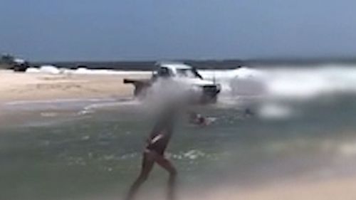 The ute ploughed into the lagoon at speed, forcing swimmers to jump for safety.