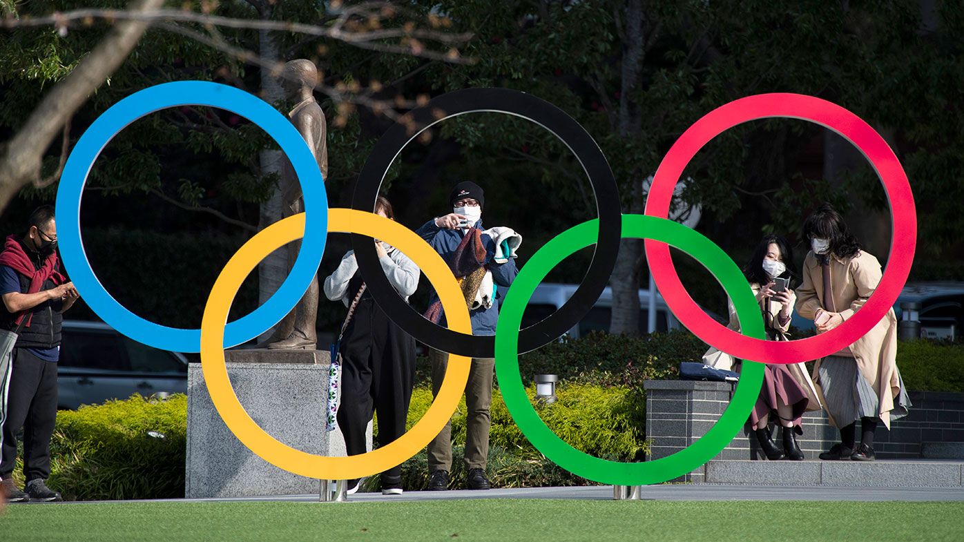 People take pictures of the Olympic rings installed by the Japan Olympic Museum in Tokyo.