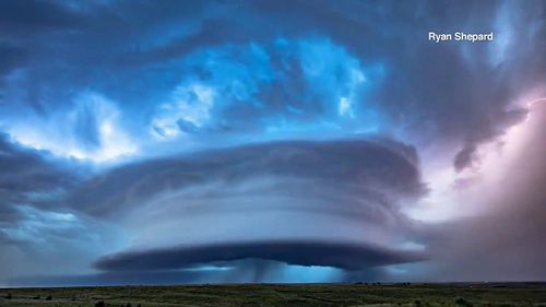 A massive supercell  was photographed hovering over Kansas cornfields.