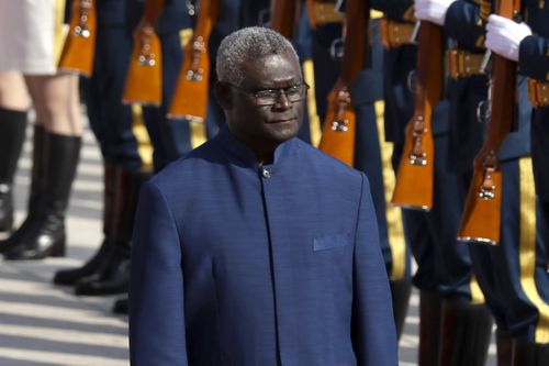 Solomon Islands Prime Minister Manasseh Sogavare reviews an honor guard during a welcome ceremony at the Great Hall of the People in Beijing, on Oct. 9, 2019. 