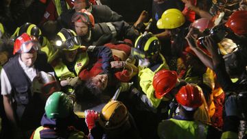 Krishna Devi Khadka is carried on a stretcher after being rescued from a building that collapsed in Kathmandu. (AAP)