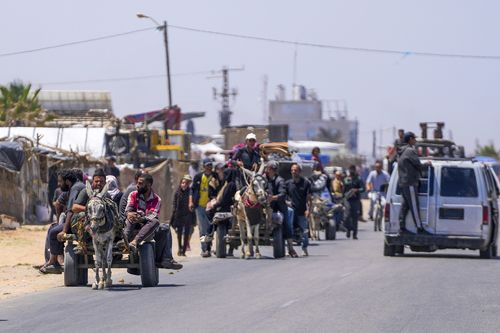 Displaced Palestinians arrive in central Gaza after fleeing from the southern Gaza city of Rafah in Deir al Balah, Gaza Strip, on Thursday, May 9, 2024.
