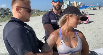 Woman handcuffed by police for wearing 'thong' swimsuit