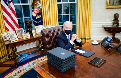 Joe Biden at Oval Office desk wearing mask
