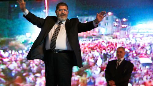Morsi in 2012, holding a rally in Cairo.