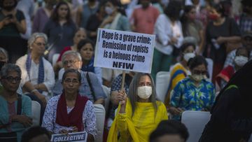 A woman holds a placard during a protest against remission of sentence by the government to convicts of a gang rape of a Muslim woman, in New Delhi, India, Saturday, August 27, 2022. 