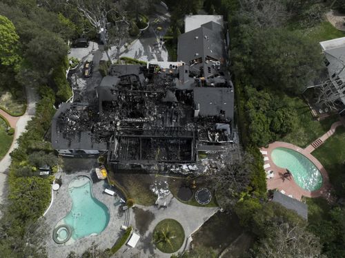 An aerial view shows a fire-damaged property, which appears to belong to Cara Delevingne, Friday, March 15, 2024, in the Studio City section of Los Angeles. (AP Photo/Jae C. Hong)