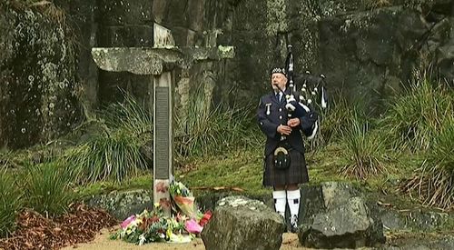 A lone piper marked the beginning of  the service. (9NEWS)