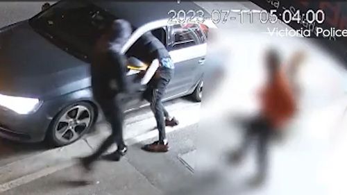 A terrifying armed robbery, in which a driver was cut by a machete after a stranger climbed into his car, on a Melbourne street was captured ﻿on CCTV. Police have released the footage as they search for men behind the incident.