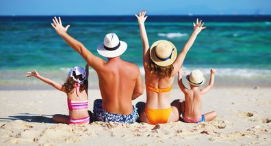 Family wearing hats at the beach. Sun safe. Happy. Happy family.