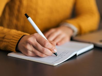 Woman writing in journal