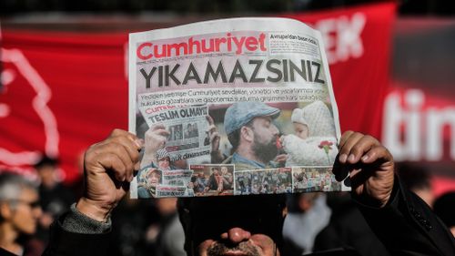 Turkish court jails nine staff from opposition newspaper 