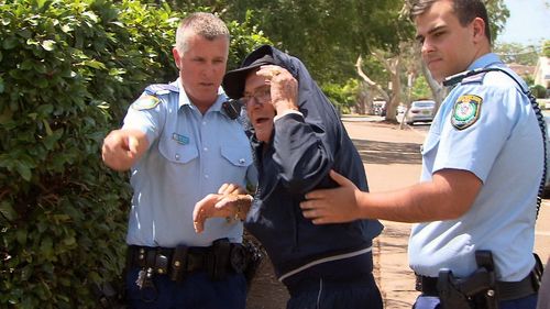 Outside of Sutherland Local Court today, the 78-year-old threw his walking stick at waiting media and was guided away by police (Supplied).