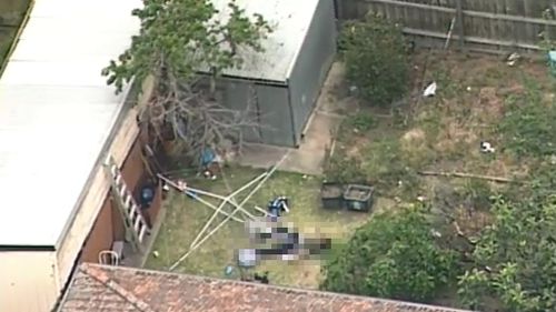 Man arrested over body in backyard west of Melbourne
