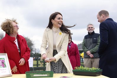 Kate, Princess of Wales, centre, laughs as she plants sweet William seeds, with Britain's Prince William next to her during a visit to the Brynawel Rehabilitation Centre near the town of Pontyclun, Wales, Tuesday Feb. 28, 2023 