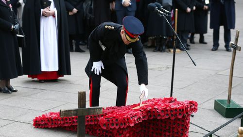 Crosses and poppies are place in the grounds of Westminster Abbey to remember those who have died during wars. (AAP)