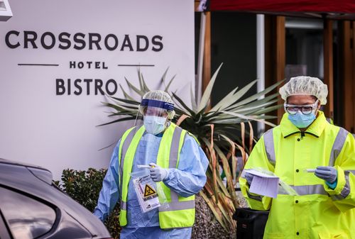 Medical staff at a pop-up COVID-19 testing clinic perform tests on drivers on July 11 at the Crossroads Hotel. 