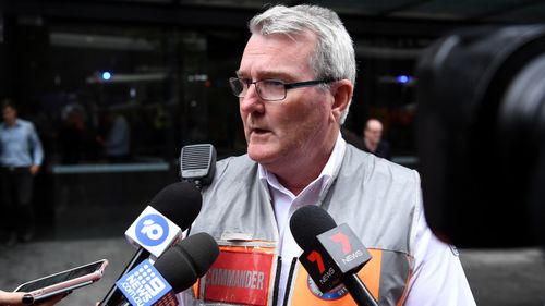 NSW Ambulance Inspector Michael Corlis speaks to the media outside 44 Market Street where emergency services cleared a possibly suspicious substance found at the Argentinian Consulate.