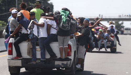 On Sunday the caravan of thousands of mostly Honduran migrants crowded into the Mexican border city of Tapachula, setting up impromptu camps in public spaces under a heavy rain.