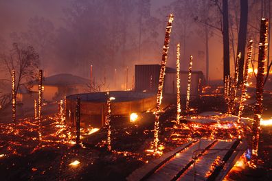 Photographs shows burning properties in Rainbow Flat last night after fire from the Hillville Fire broke containment lines and crossed the Pacific Highway Several homes and countless structures were lost in the area. The remains of a truck is left to burn on the Pacific Highway after fire closed the Highway.