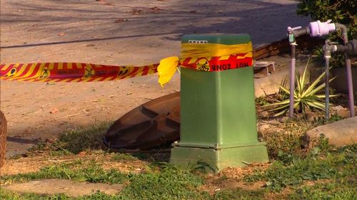 Police have locked down a home in Sydney's north west after a manhole cover exploded in the street.