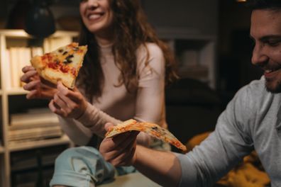 close us people eating pizza at home