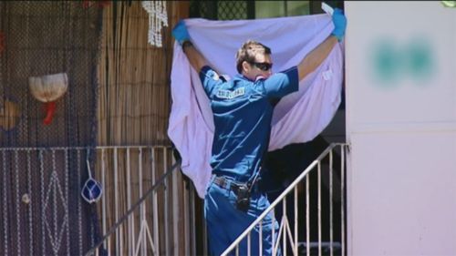 Police secure the crime scene in Manoora. (9NEWS)