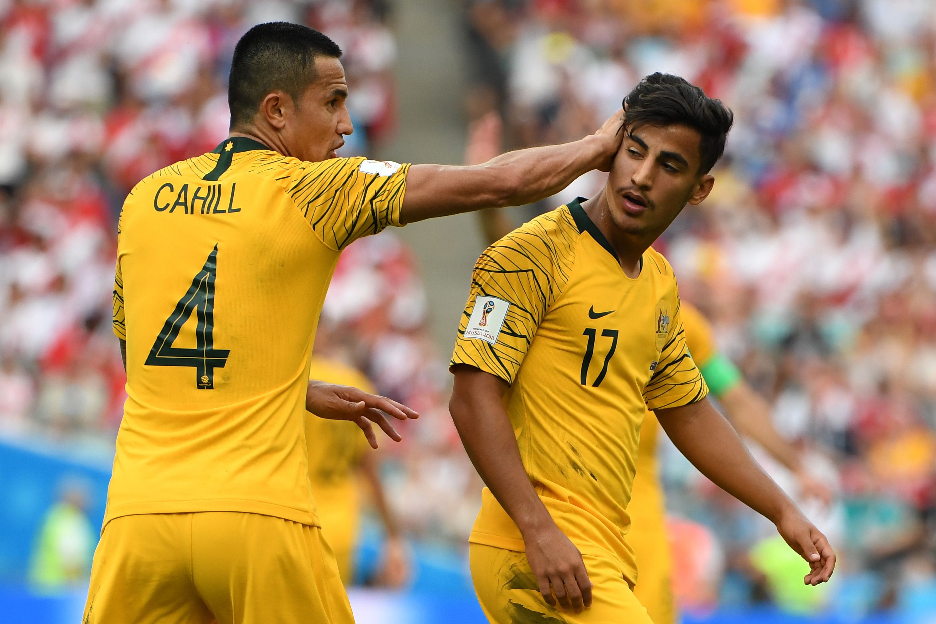 Daniel Arzani gets a pat on the head from Tim Cahill.