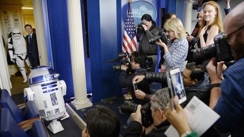 Reporters line-up to take photos of R2D2. (AAP)