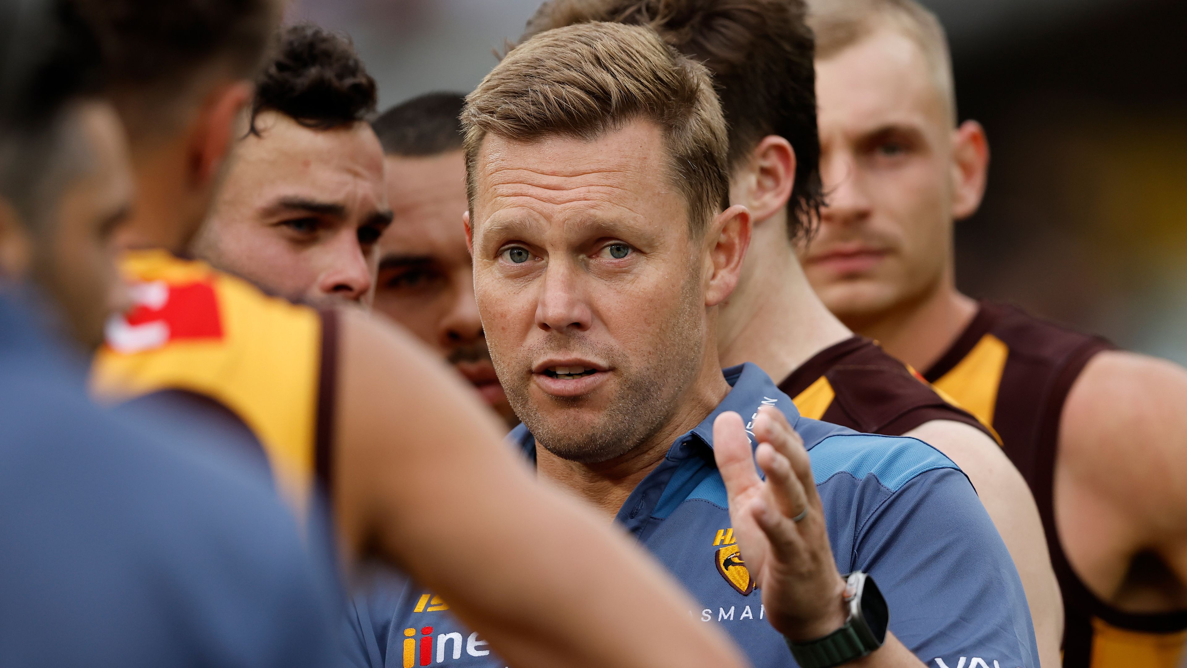 MELBOURNE, AUSTRALIA - MARCH 19: Sam Mitchell, Senior Coach of the Hawks addresses his players during the 2023 AFL Round 01 match between the Hawthorn Hawks and the Essendon Bombers at the Melbourne Cricket Ground on March 19, 2023 in Melbourne, Australia. (Photo by Dylan Burns/AFL Photos)