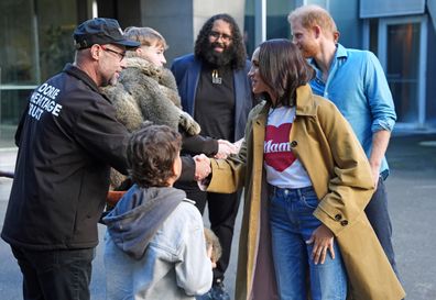 MELBOURNE, AUSTRALIA - APRIL 16: Anthony Appo, 9, shows a native Marngrook ball to the Duke and Duchess of Sussex, Prince Harry and Meghan Markle as they meet representatives from the Koorie Heritage Trust before taking part in the Scar Tree Walk on day three of the royal tour on April 16, 2026 in Melbourne, Australia. The Scar Tree Walk is a journey that connects traditional and contemporary Aboriginal cultures and history of the Kulin Nation. The Duke and Duchess of Sussex are on a four-day holiday