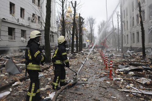 Firefighters extinguish a building of Ukrainian Security Service (SBU) after a rocket attack in Kharkiv, Ukraine's second-largest city, Ukraine, Wednesday, March 2, 2022.