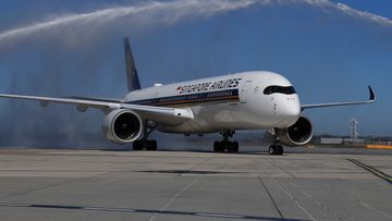 Flight SQ237 from Singapore receives a water canon salute on the tarmac at Tullamarine Airport on November 1, 2021 in Melbourne, as quarantine-free travel begin for Aussies.