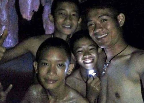 The boys smiling in a selfie in the cave. They've now eaten and are building strength, being watched over by two Thai doctors who have joined the group. Picture: Supplied.