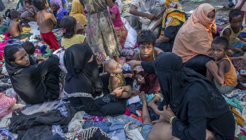 Newly arrived Rohingya Muslims, who crossed over from Myanmar into Bangladesh, rest on clothes that were earlier distributed to other refugees at Teknaf, Bangladesh. (AP)