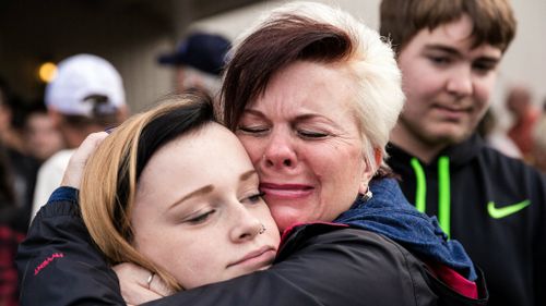 A student is embraced after the shooting. (AAP)