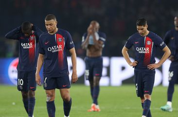 Kylian Mbappe of Paris Saint-Germain looks dejected with teammates after defeat to Borussia Dortmund during the UEFA Champions League semi-final second leg match between Paris Saint-Germain and Borussia Dortmund at Parc des Princes.