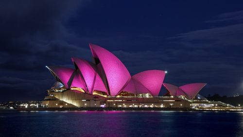 The renowned sails of the Sydney Opera House are glowing pink in honour of the Australian icon Olivia Newton-John.