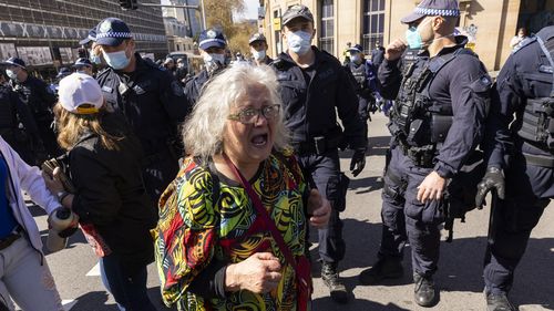 A woman surrounded by police near Victoria Park, Sydney.