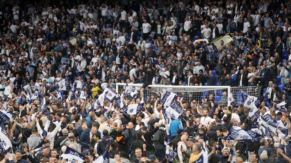 Tottenham Hotspur fans flood the field after downing Manchester United to finish second in EPL